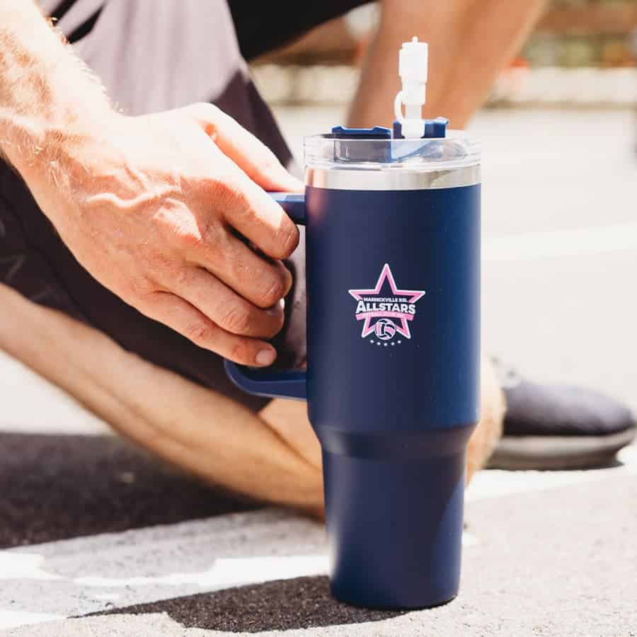 A drink bottle in navy blue with a straw and a logo. The design features an easy-grip handle.