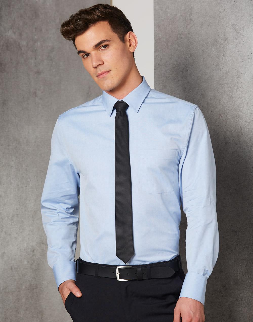 A light blue men's button-up shirt with long sleeves, featuring a collar and a black tie. The model is standing against a neutral background.