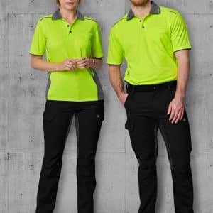 A pair of models wears bright green and grey work shirts with black rip-stop poly/cotton stretch work pants.