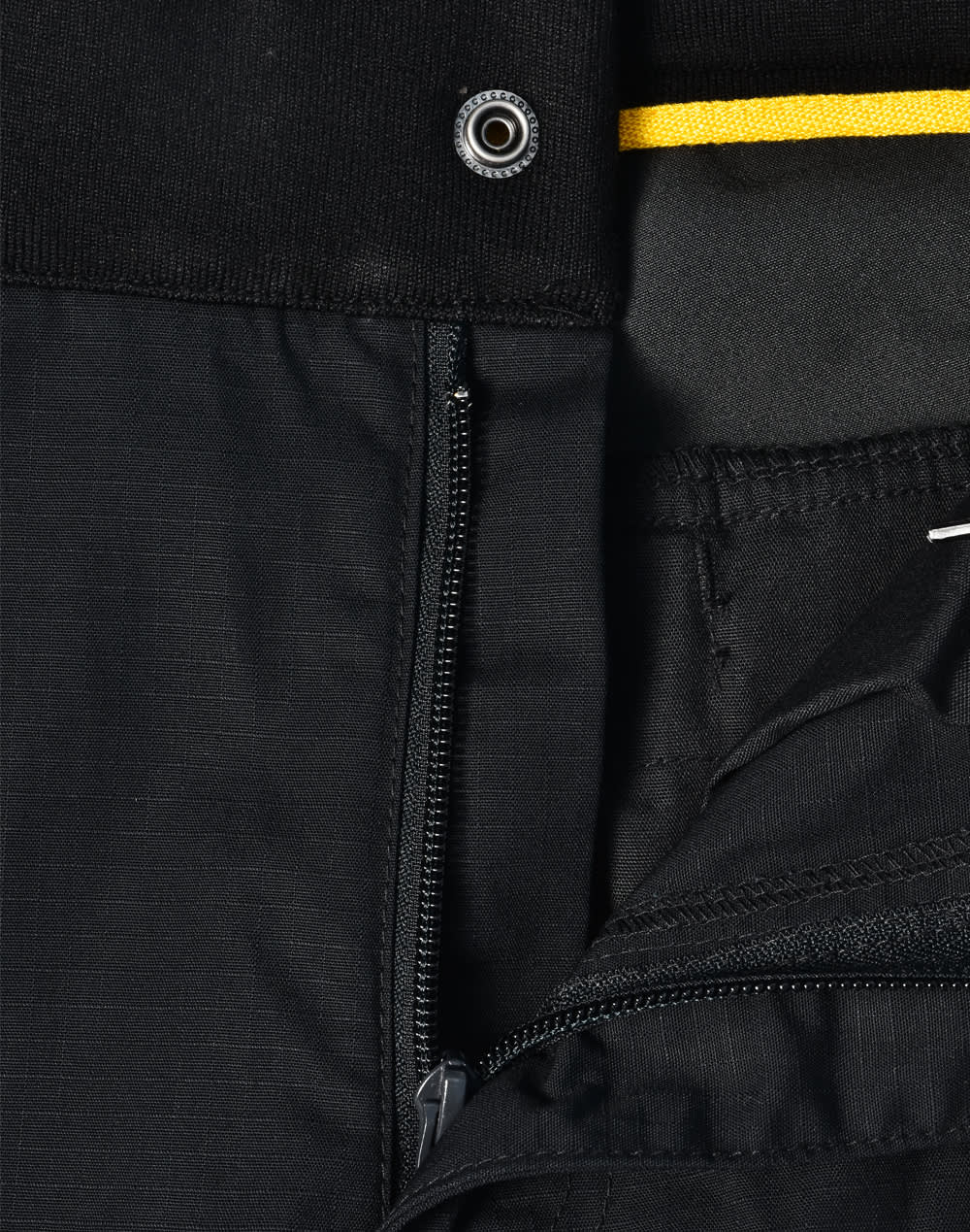 Black work pants featuring a zip and button closure, with a contrasting yellow detail at the waistband.