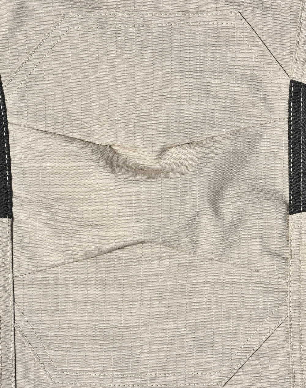 Light grey fabric of work pants featuring detailed stitching and black accents, with a logo present.