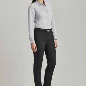 A model wears women's slim leg pants in black, paired with a light grey shirt and black heels. Features branding on the pants.