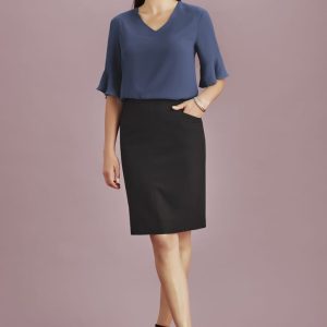 A model wearing a women's pencil skirt in black paired with a blue top, featuring a pocket and stylish heels.