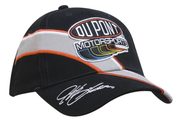 A black brushed cotton cap with embroidered trim and inserts, featuring a logo and signed detailing.