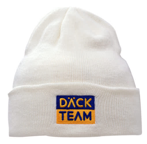 A cream acrylic beanie with a deep fit, featuring a logo in blue and gold.