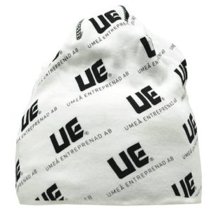 A white beanie featuring a repeating black logo pattern. It has a rounded top and a loose fit.