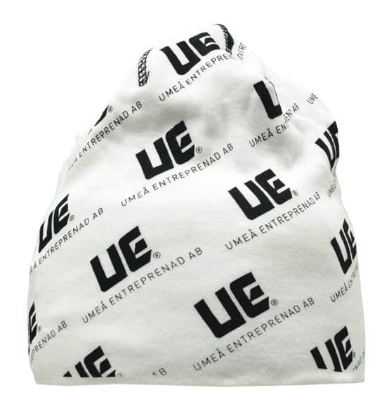 A white beanie featuring a repeating black logo pattern. It has a rounded top and a loose fit.
