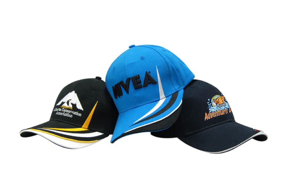 Three caps displayed: a black cap with white and yellow details, a bright blue cap with a logo, and a black cap with a logo.