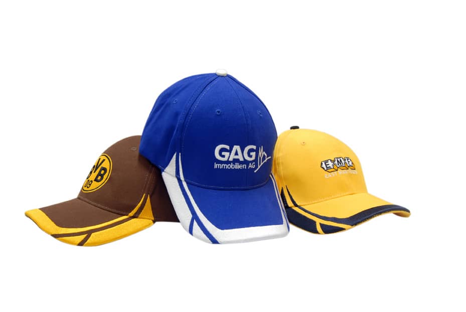 Three caps in brown, blue, and yellow, featuring embroidered designs and contrasting peak and crown detailing.