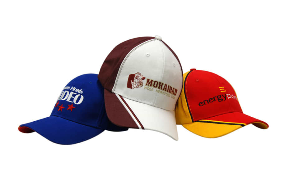 A collection of three caps in blue, white, and red, featuring various logos and embroidered designs.