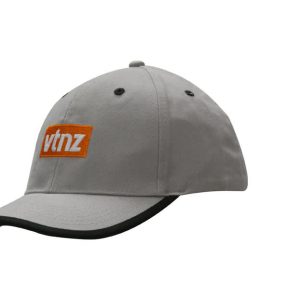 A grey cap with a peak trim and an orange logo on the front.