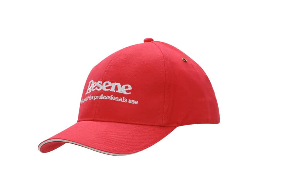 A red brushed heavy cotton cap featuring a sandwich trim and brass eyelets, with a logo visible on the front.