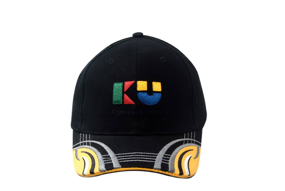 A black cap featuring embroidered design on the peak, with yellow sandwich trim and fabric inserts.