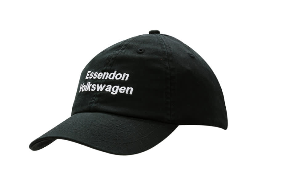 A black washed chino twill cap featuring a logo on the front and an adjustable strap at the back.