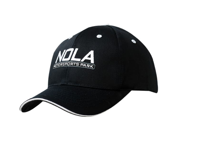 A black cap with a curved peak and fabric inserts on the crown, featuring a logo.