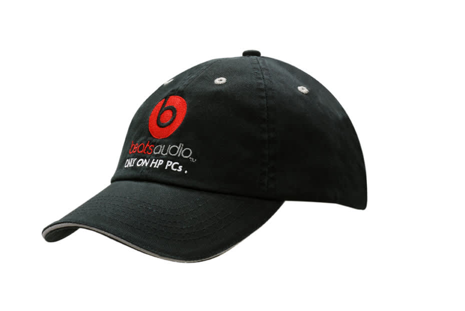 A black chino twill cap with sandwich trim and a back strap stripe, featuring a logo.