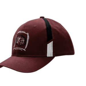 A burgundy cap with fabric inserts on the crown and a logo on the front. Features a curved brim and contrasting accents.