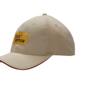 A beige mesh knit cap with red sandwich trim and a logo on the front.