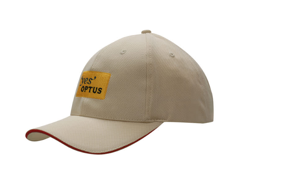 A beige mesh knit cap with red sandwich trim and a logo on the front.