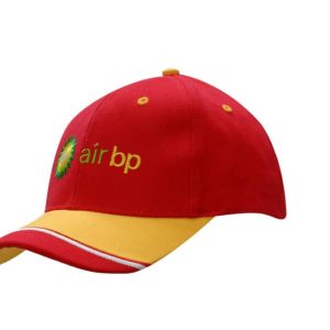 A red and yellow cap featuring an embroidered logo on the front and a fabric insert on the peak.