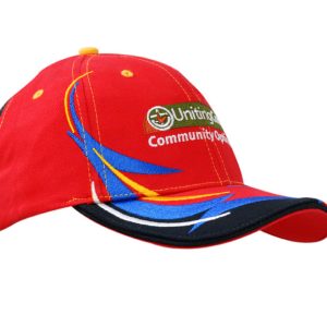 A red cap with embroidered trim in blue and yellow, featuring a logo on the front.