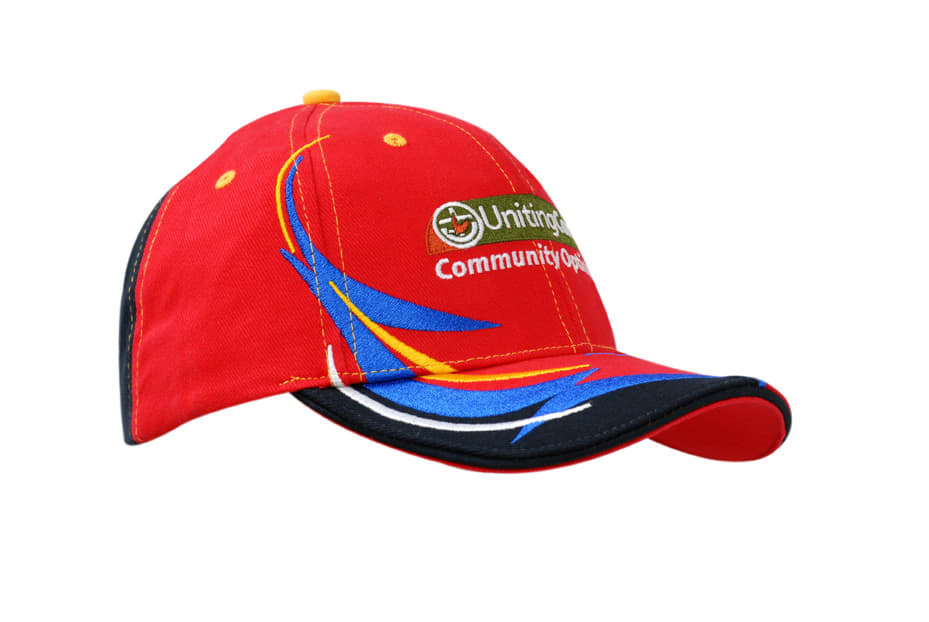 A red cap with embroidered trim in blue and yellow, featuring a logo on the front.