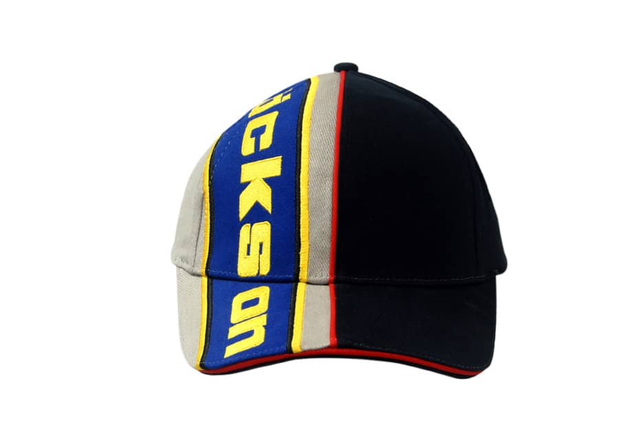 A black and beige cap with blue and yellow sandwich trim and embroidered lines on the crown and peak, featuring a logo.