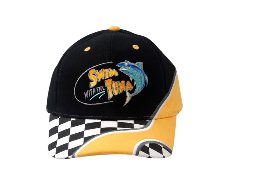 A black and yellow cap featuring embroidered fish design and printed check pattern on the peak, with a logo.