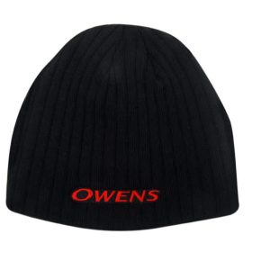A black cable knit roll-down beanie with a logo in red. The beanie has a textured finish.