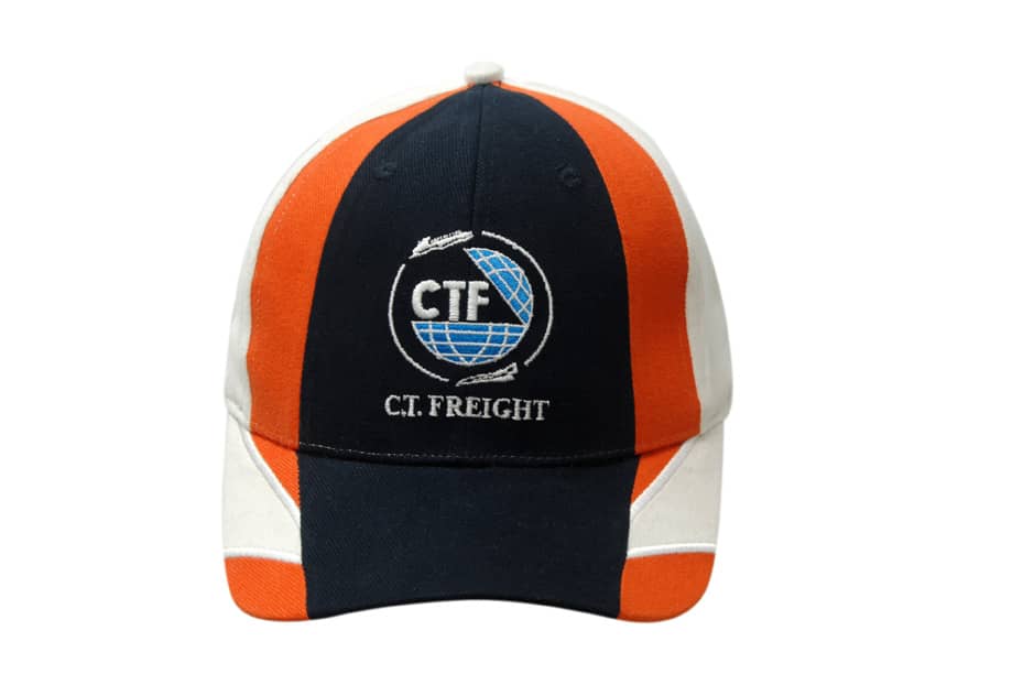 A cap featuring a navy blue, orange, and cream design with embroidered details and a logo.