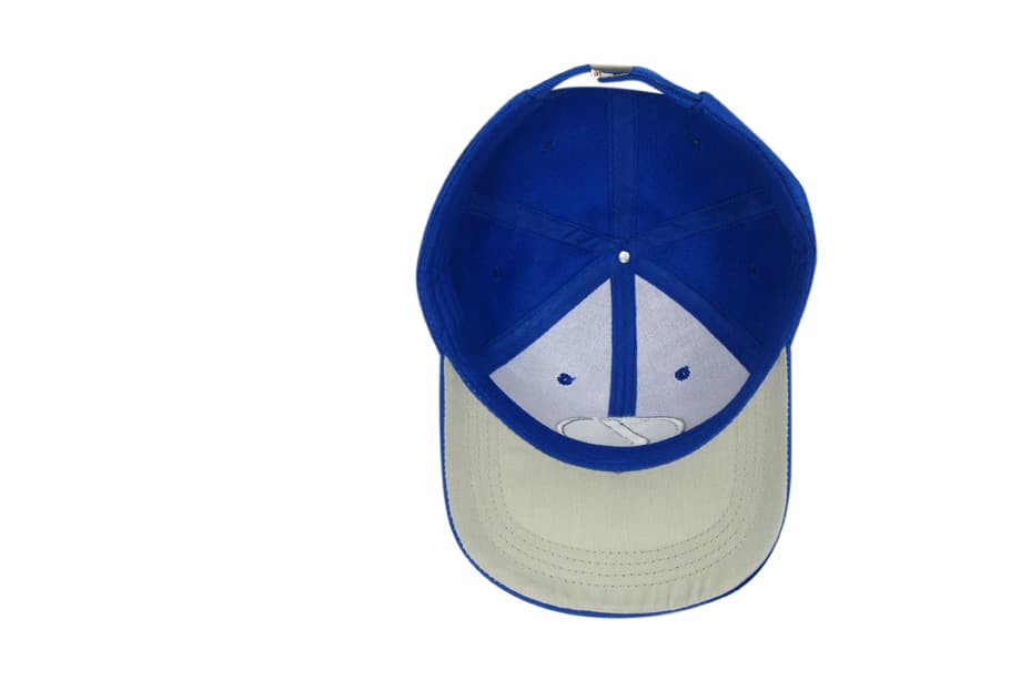 Blue cap with a contrasting cream peak and an interior lining. Features a logo on the front.