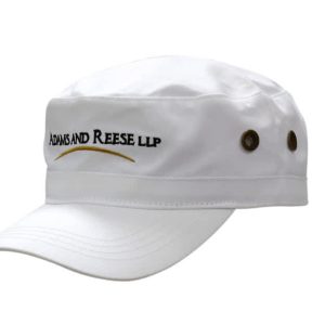 A white military style cap with a stiff brim and side ventilation holes, featuring a logo on the front.