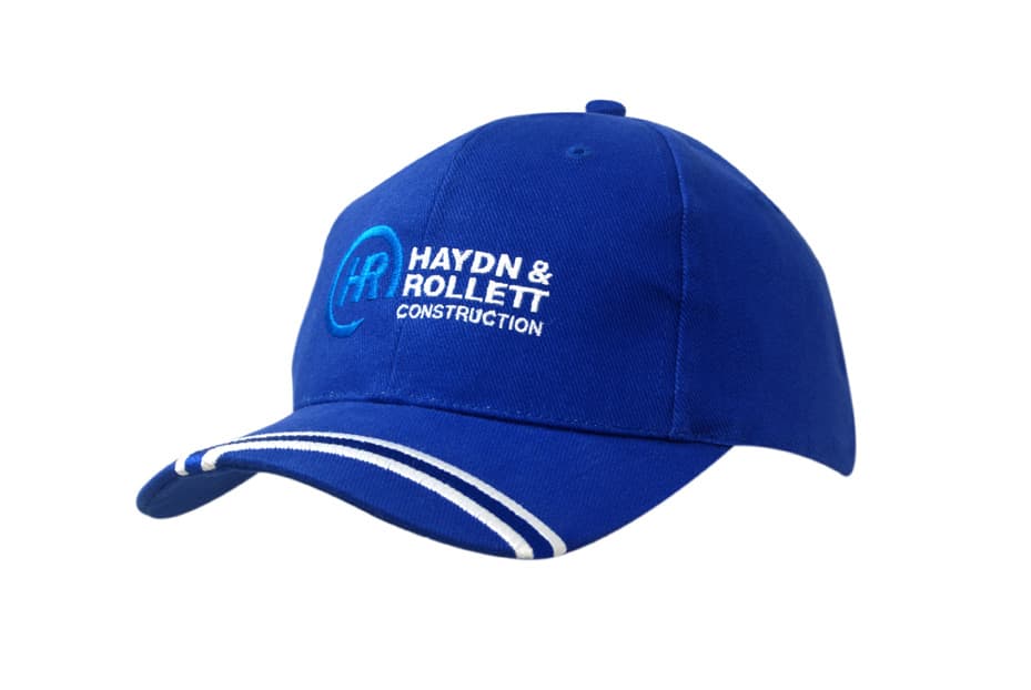 A blue brushed heavy cotton cap with an embroidered logo on the peak and white striped detailing.