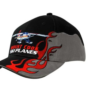 A black and grey cap featuring flame embroidery on the peak and a plane graphic on the crown.