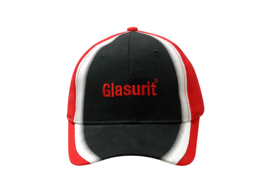 A black and red cap with a shadow print on the crown and peak, featuring a logo on the front.