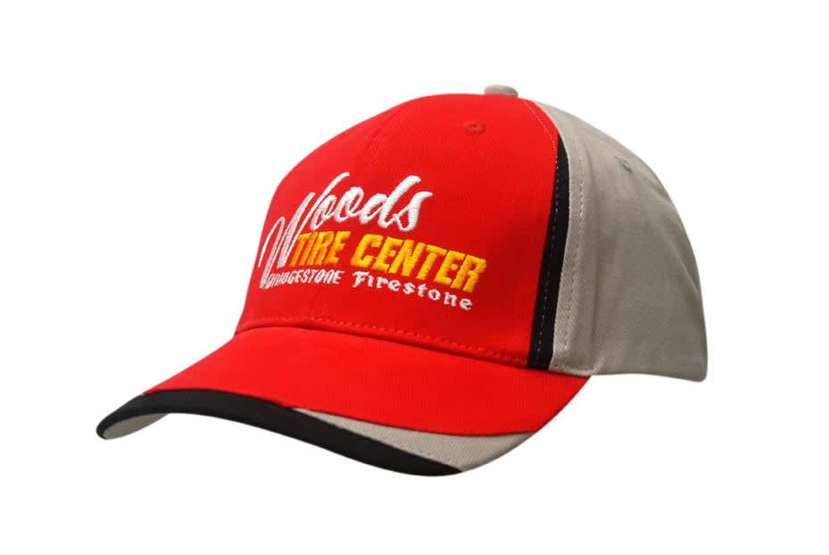 A red and grey cap with fabric inserts on the crown and peak, featuring a logo on the front.