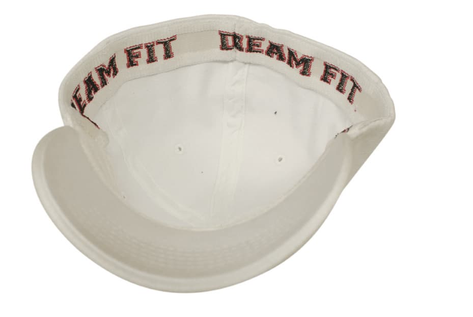 A white fitted cap featuring a textured interior and a logo on the inner band.