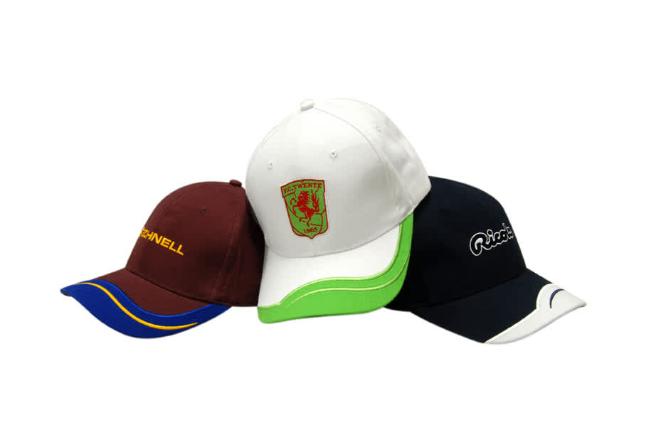 Three caps displayed together: a burgundy cap with a logo, a white cap with an emblem, and a navy cap with branding.