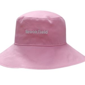 A pink cotton twill ladies hat with a wide brim and a logo on the front.