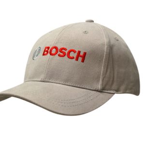 A beige cap with a contrasting peak, featuring a logo on the front and embroidered text in red.