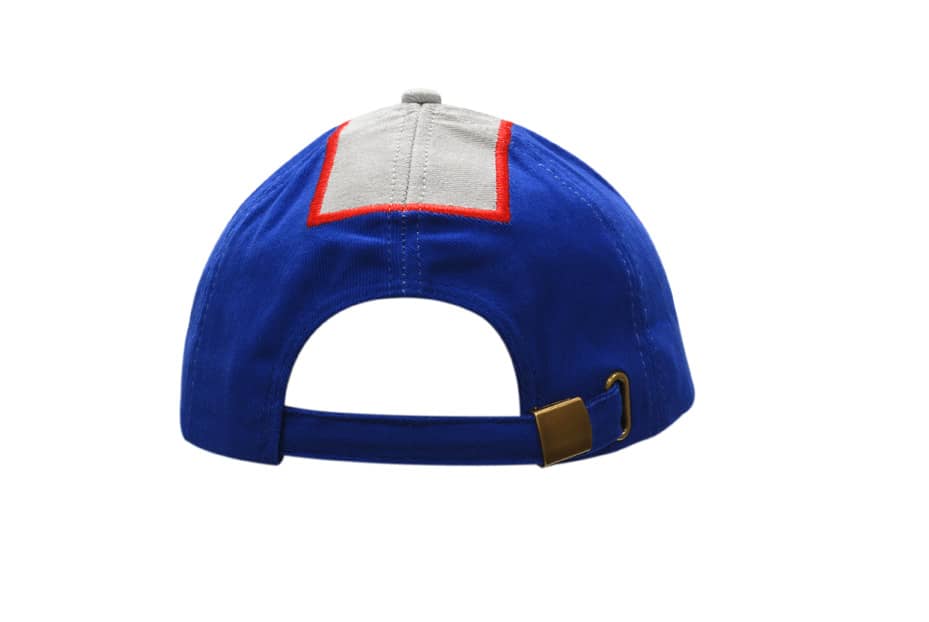 A blue cap featuring a fabric insert on the crown and peak, with a strap at the back and a logo.