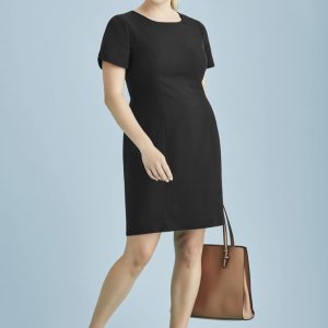 A black short sleeve shift dress paired with a brown handbag, modelled against a light blue background.