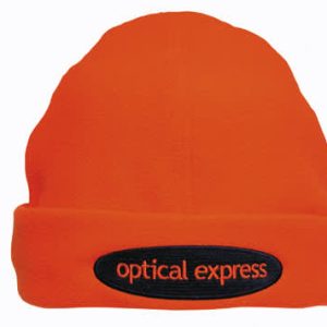 An orange beanie with a black patch featuring a logo. The beanie has a soft, textured appearance.