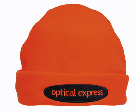 An orange beanie with a black patch featuring a logo. The beanie has a soft, textured appearance.