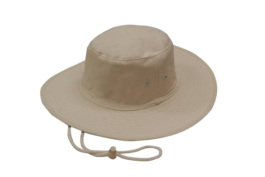 A beige canvas hat with a wide brim and a chin strap, featuring ventilation eyelets.