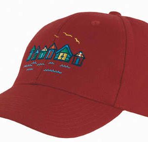 A maroon cap featuring an embroidered design of colourful houses and water, along with a logo on the front.
