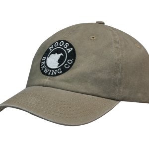 A khaki cap with a curved brim and an embroidered logo. Made from enzyme washed pigment dyed cotton twill.