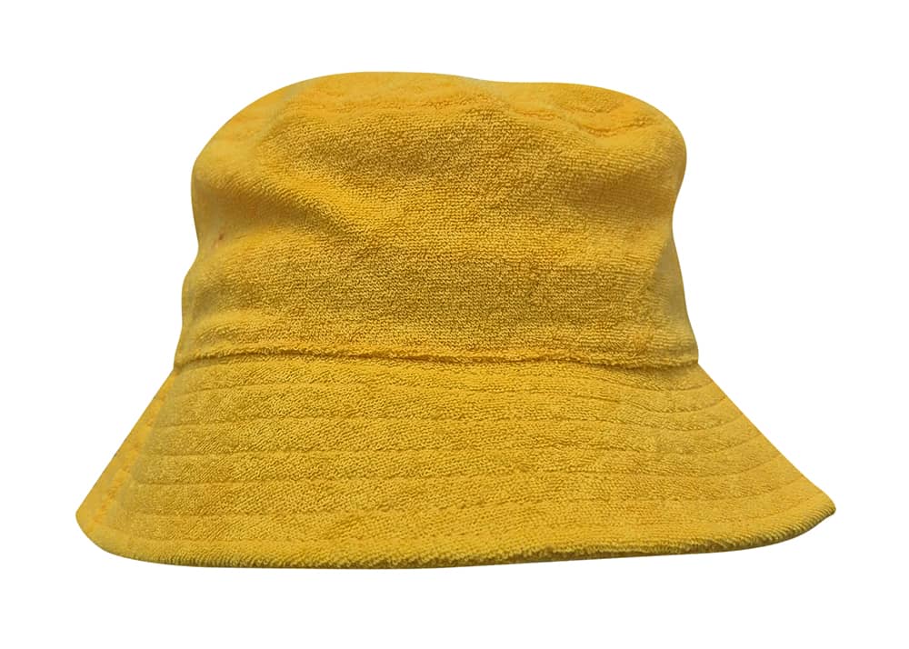 A yellow terry towelling bucket hat with a wide brim and a textured finish. It features a logo on the side.