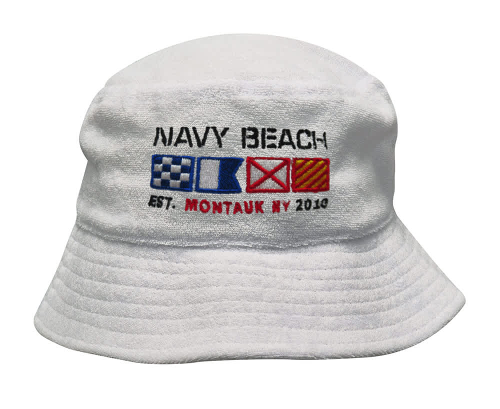 A white terry towelling bucket hat featuring an embroidered logo with nautical flags and text.