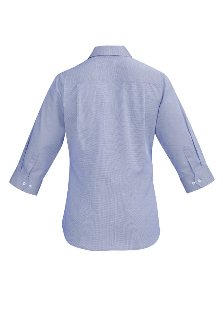 A light blue women's button-up shirt with 3/4 sleeves and a back yoke detail. It features a logo on the back.